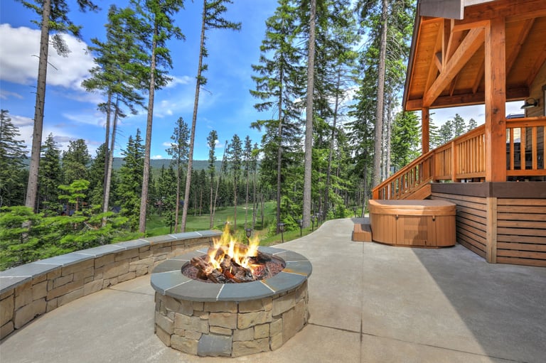 New Mountain vacation Cedar brown home exterior with great back porch with hot tub and fire pit