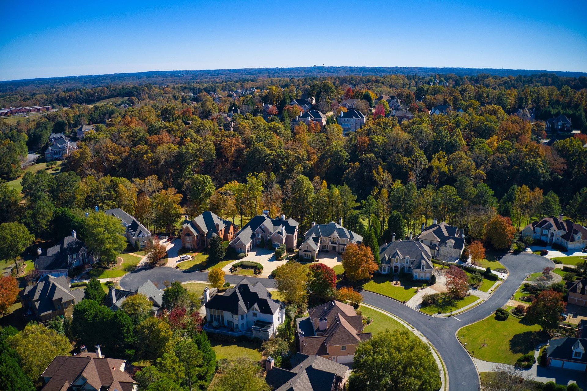 Panoramic aerial view of luxury homes in an upscale Pennsylvania neighborhood with beautiful fall foliage