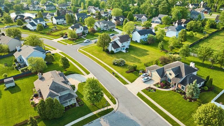 Landscaping on middle-class homes aerial neighborhood fresh cut lawns in summer
