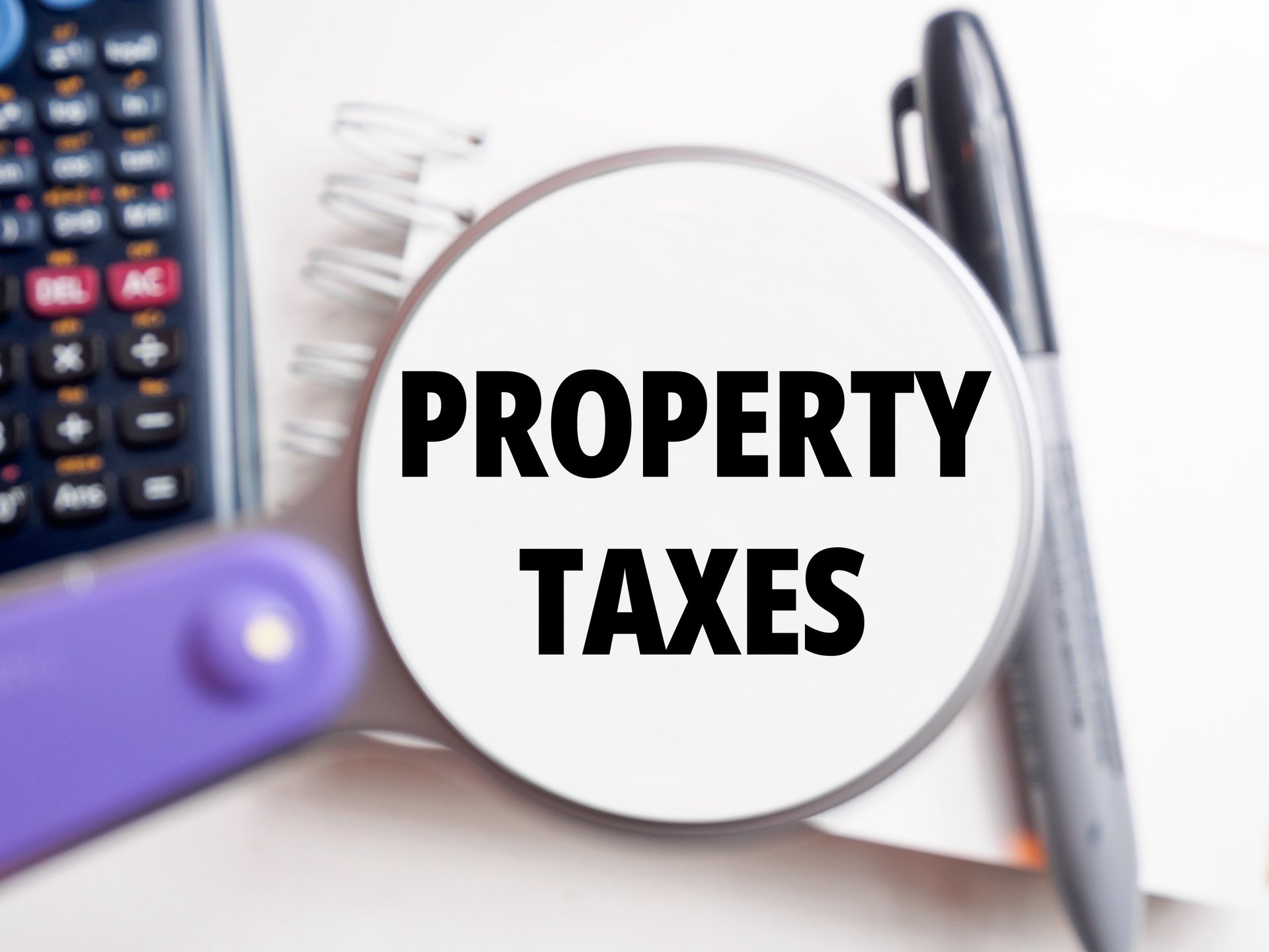 "Property Taxes" text under magnification tax background