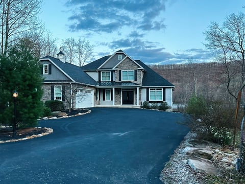 Elegant modern home nestled among lush trees in Pennsylvania during serene evening lighting