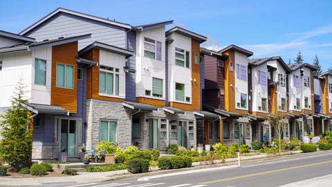 A row of modern townhomes showcasing contemporary architecture with clean lines and landscaped walkways