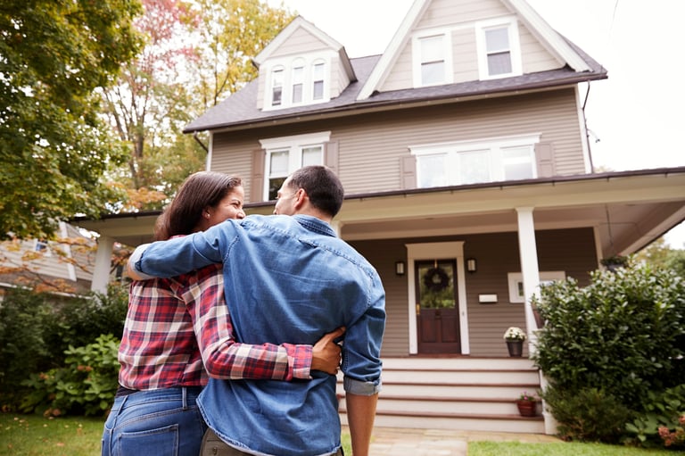Couple walking towards their elegant suburban home
